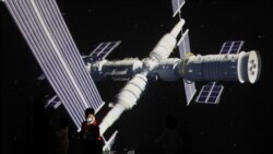 A child stands near a giant screen showing images of the Tianhe space station at show on the development of China's space exploration on Space Day at the Science and Technology Museum in Beijing, China, April 24. 2021. (Reuters)