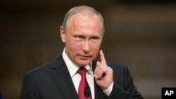 In this file photo from Monday, May 29, 2017, Russian President Vladimir Putin gestures as he speaks during a shared news conference with French President Emmanuel Macron at the Palace of Versailles, near Paris, France. (AP Photo/Alexander Zemlianichenko)