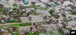 This image made available by International Federation of Red Cross and Red Crescent Societies (IFRC) on Monday March 18, 2019, shows an aerial view from a helicopter of flooding in Beira, Mozambique.