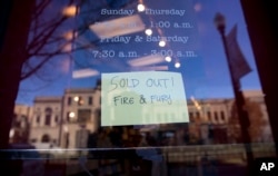A sign posted at the door for Kramerbooks & Afterwords Cafe shows that the book "Fire and Fury: Inside the Trump White House" is sold out at the bookstore located in the Dupont Circle neighborhood in Washington, Friday, Jan. 5, 2018. (AP Photo)