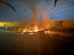 Burning debris is seen on a road near Baghdad International Airport, which according to Iraqi paramilitary groups were caused by three rockets hitting the airport in Iraq, January 3, 2020, in this image obtained via social media. Iraqi Security Media Cell
