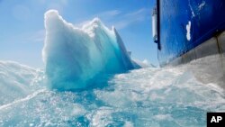 FILE - In this July 21, 2017 file photo, broken sea ice emerges from under the hull of the Finnish icebreaker MSV Nordica as it sails through the Victoria Strait while traversing the Arctic's Northwest Passage.(AP Photo/David Goldman, File)