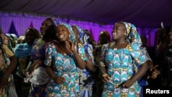 Some of the girls who were kidnapped by Boko Haram militants in the Nigerian town of Chibok, are seen dancing joyfully during the the send-forth dinner organised for them in Abuja, Nigeria.