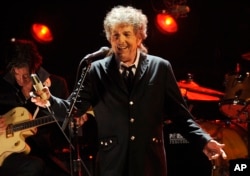 FILE - In this Jan. 12, 2012, file photo, Bob Dylan performs in Los Angeles.
