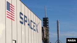 In this photo provided by NASA, a SpaceX Falcon 9 rocket and Dragon spacecraft await liftoff from NASA Kennedy Space Center in Cape Canaveral, Fla., on Aug. 14, 2017. Dragon arrived at the ISS Wednesday with a few tons of research — plus ice cream. (Kim Shiflett/NASA via AP)
