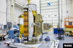 Members of the DART team carefully inspect the spacecraft before performing vibration tests in July 2021. (Image Credit: NASA/Johns Hopkins APL/Ed Whitman)