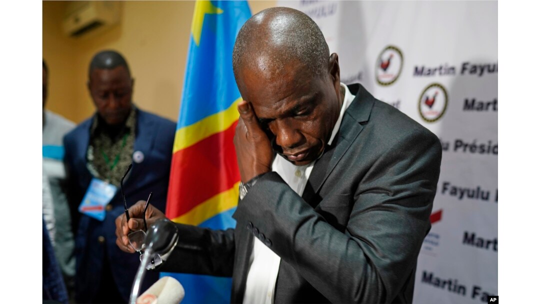 Opposition candidate Martin Fayulu wipes his face before speaking to the press at his headquarters in Kinshasa, DRC, Jan. 10, 2019. Fayulu, who came second in the presidential poll behind Felix Tshisekedi, called the results fraudulent.