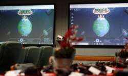 FILE - Monitors are illuminated in the NORAD Tracks Santa center at Peterson Air Force Base, Monday, Dec. 23, 2019, in Colorado Springs, Colo.