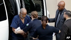James Mathew Bradley Jr., 60, of Clearwater, Florida, left, arrives at the federal courthouse for a hearing, July 24, 2017, in San Antonio. Bradley was arrested in connection with the deaths of multiple people packed into a broiling tractor-trailer. (AP Photo/Eric Gay)