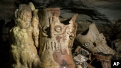 Pre-columbian artifacts sit in a cave at the Mayan ruins of Chichen Itza, Yucatan, Mexico, Tuesday, Feb. 19, 2019. (Karla Ortega/Mexico's National Institute of Anthropology and History via AP)