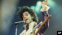 Rock singer Prince performs at the Forum in Inglewood, Calif., during his opening show, Feb. 18, 1985. (AP Photo/Liu Heung Shing)