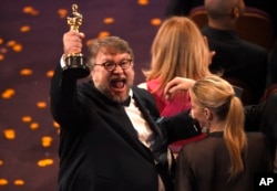 Guillermo del Toro, winner of the award for best director for "The Shape of Water" celebrates in the audience at the Oscars on Sunday, March 4, 2018, at the Dolby Theatre in Los Angeles. (Photo by Chris Pizzello/Invision/AP)