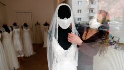 Fashion designer and tailor Friederike Jorzig presents a face mask for wedding dresses in her shop 'Chiton', as the spread of the coronavirus disease (COVID-19) continues in Berlin, Germany, March 31, 2020. REUTERS/Fabrizio Bensch