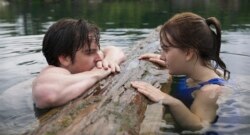 This image released by Apple TV+ shows Ferdia Walsh-Peelo, left, and Emilia Jones in a scene from "CODA." (Apple TV+ via AP)