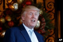 President-elect Donald Trump speaks to reporters at Mar-a-Lago in Palm Beach, Fla.