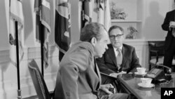 In this Oct. 9, 1973 file photo, President Richard M. Nixon meets Secretary of State Henry Kissinger in the Oval Office of the White House in Washington DC.
