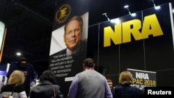 People sign up at the booth for the National Rifle Association at the Conservative Political Action Conference at National Harbor, Maryland, Feb. 23, 2018.