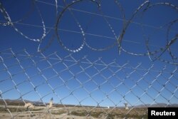 The installations of a Chinese space station are seen behind a fence in Las Lajas, Argentina, January 22, 2019. (REUTERS/Agustin Marcarian)