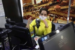 Diana Lopez presents a one-hour class through Bacata Stereo radio station in Funza, Colombia, Wednesday, May 13, 2020.