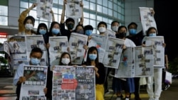 Staff members of Apple Daily and its publisher Next Digital pose with the final edition of Apple Daily at its headquarters in Hong Kong, China June 24, 2021. (REUTERS/Tyrone Siu)