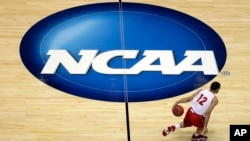 FILE - Wisconsin's Traevon Jackson dribbles past the NCAA logo during practice at the NCAA men's college basketball tournament March 26, 2014, in Anaheim, Calif. (AP Photo/Jae C. Hong, File)