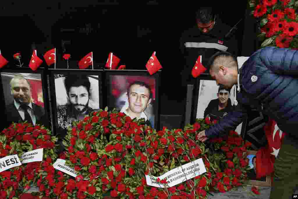 A man leaves a carnation outside Reina nightclub as people have gathered to remember the victims of a deadly New Year's terror attack a year ago, in Istanbul, Sunday Dec. 31 2017.