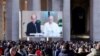 Un sacerdote lee junto al papa Francisco la bendición tradicional del mediodía, televisada en vivo desde la capilla del hotel vaticano donde vive Francisco, el 26 de noviembre de 2023.