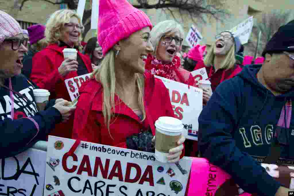 Women with bright pink hats and signs begin to gather early and are set to make their voices heard on the first full day of Donald Trump's presidency, Jan. 21, 2017 in Washington. ( AP Photo/Jose Luis Magana)
