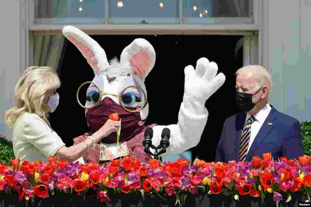 U.S. President Joe Biden, first lady Jill Biden and a person wearing an Easter Bunny costume are see on the Blue Room Balcony of the White House in Washington.