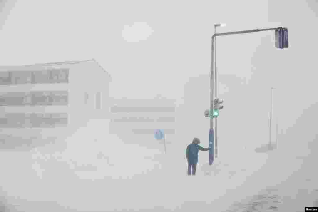 A person is seen during a snowstorm in Nuuk, Greenland, March 14, 2022.