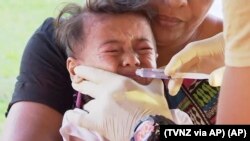 In this November 2019, image from video, a child gets vaccinated against measles at a health clinic in Apia, Samoa.