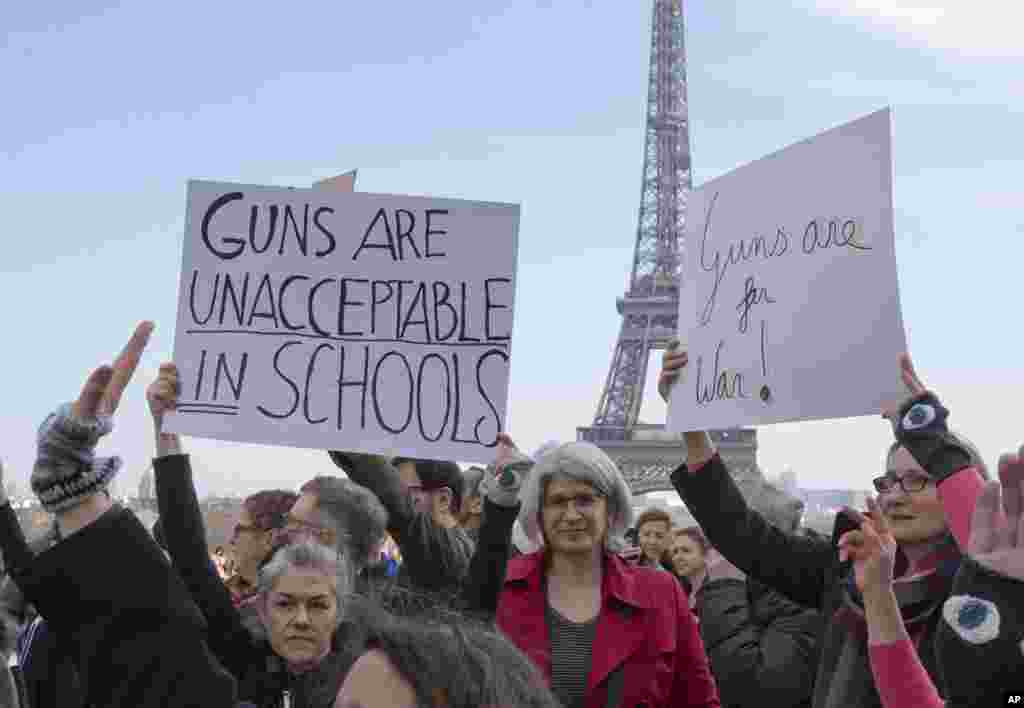 People hold banners during the "March For Our Lives" event in Paris, March 24, 2018. (AP Photo/Michel Euler)