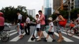FILE - Children and their parents are seen on their way to the school in Tianhe district in Guanghzou, China, September 4, 2019. (REUTERS/Jorge Silva/File Photo)