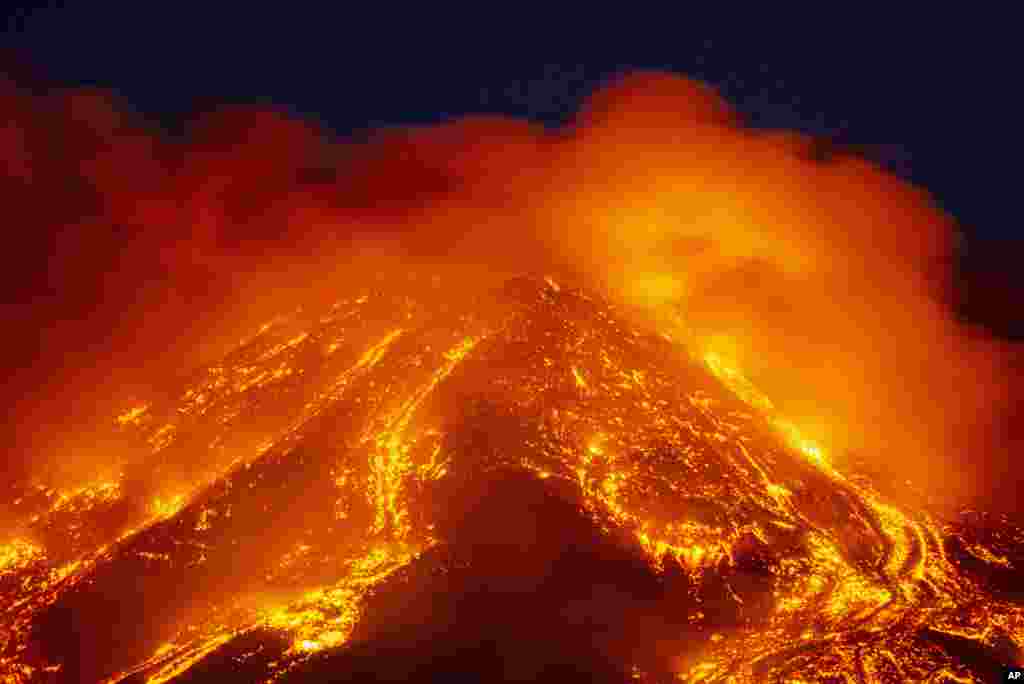 Lava gushes from the Mt Etna volcano near Catania, Sicily, Italy, Feb. 16, 2021.
