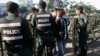 FILE - Riot police stand guard at a blocked street outside the supreme court in Phnom Penh, Cambodia, Nov. 16, 2017. The court ultimately dissolved the opposition Cambodia National Rescue Party, seen as another move by authoritarian Prime Minister Hun Sen to remove threats to his power ahead of elections next year.