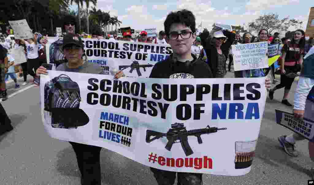 People take part in a "March For Our Lives" rally Saturday, March 24, 2018, in Parkland, Fla.