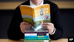 FILE - A pile of challenged books appear at the Utah Pride Center in Salt Lake City on Dec. 16, 2021. (AP Photo/Rick Bowmer, File)
