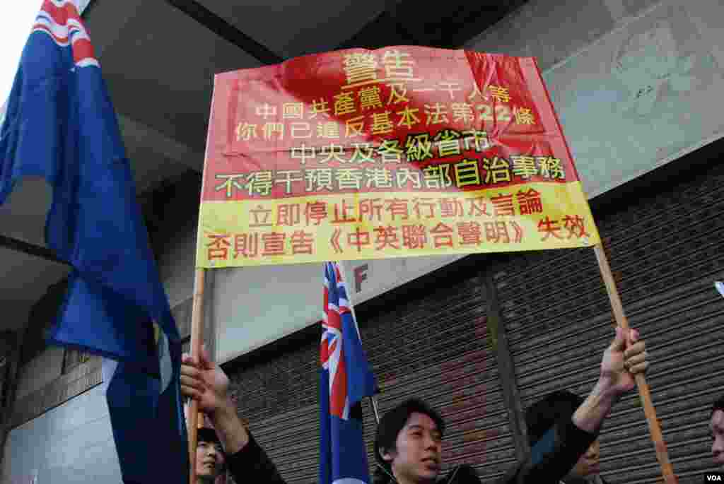 示威者高舉標語,要求北京遵守基本法22條,不得干預香港內部事務(美國之音湯惠芸攝)