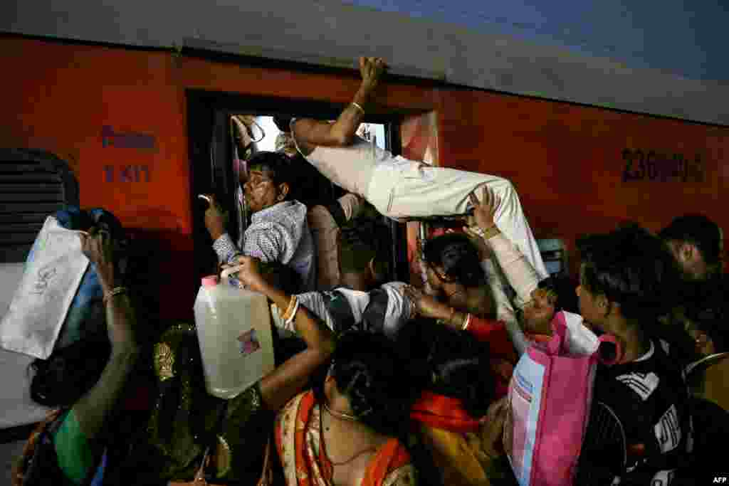Pilgrims board a train after visiting the Kashi Vishwanath temple, at a railway station in Varanasi, India on February 17, 2025, following their trip from the Maha Kumbh Mela festival in Prayagraj.