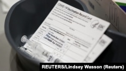FILE - A Pfizer coronavirus disease vaccine card is seen at a mass vaccination site in Seattle, Washington, U.S. March 13, 2021. (REUTERS/Lindsey Wasson)