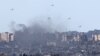 Humanitarian aid falls over northern Gaza as seen from Israel's southern border with the Gaza Strip on March 7, 2024, amid the ongoing conflict between Israel and the Palestinian group Hamas.