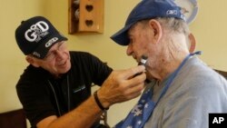 FILE -- Caregiver Warren Manchess, 74, left, shaves Paul Gregoline, 92, in Noblesville, Indiana. The share of the U.S. population over age 60 is expected to rise by 40 percent between 2010 and 2050.