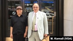 Guillermo Peralta poses with his pro-bono lawyer, Craig Shagin, at the entrance of the U.S. Immigration Court in Philadelphia.