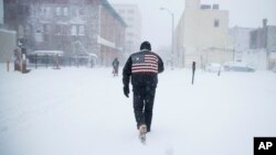 A man pushes his way through a winter snowstorm in Atlantic City, N.J., Thursday, Jan. 4, 2018. A massive winter storm swept from the Carolinas to Maine on Thursday. (AP Photo/Matt Rourke)
