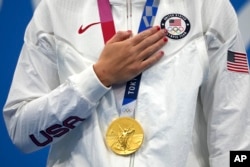 FILE - Katie Ledecky of the United States with her gold medal after winning the women's 1500-meters freestyle final at the 2020 Summer Olympics, on July 28, 2021, in Tokyo, Japan. (AP Photo/Matthias Schrader, File)