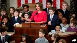 House Speaker Nancy Pelosi of California, surrounded by her grandchildren and other children, pounds the gavel at the Capitol in Washington, Thursday, Jan. 3, 2019. (AP Photo/Carolyn Kaster)